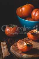 Slices of persimmon on cutting board