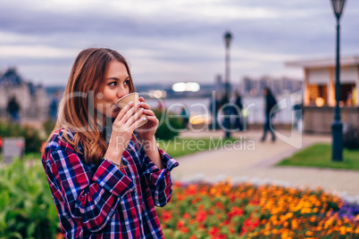 Beautiful young woman drinking coffee