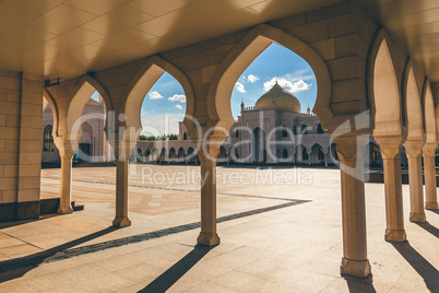 View of the white mosque through the Arches