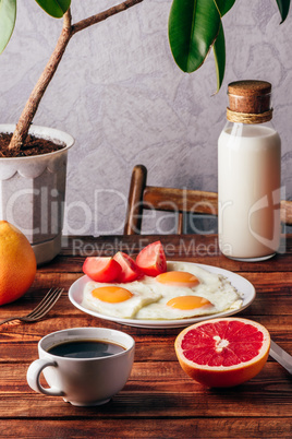 Fried eggs and cup of coffee