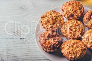 Cooked oatmeal muffins on white plate.