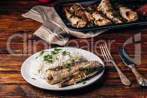 Baked hake carcasses with rice