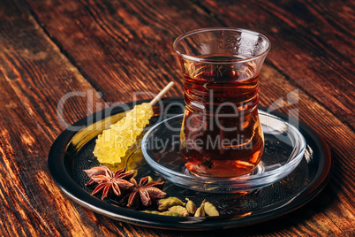 Oriental glass with tea spices on tray