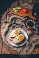 Breakfast toasts with vegetables and fried eggs with cup of coff