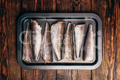 Hake carcasses on baking sheet