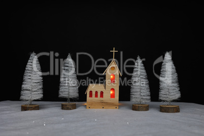 Landscape with a small church made of plywood on Christmas night