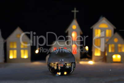 Christmas town reflected in a glass ball