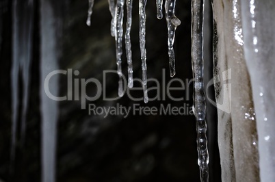 Icicles hang from the rock, place for text, template for design