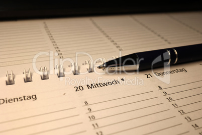 A calendar and a pen lie on the table