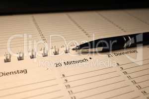 A calendar and a pen lie on the table
