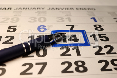 A calendar and a pen lie on the table