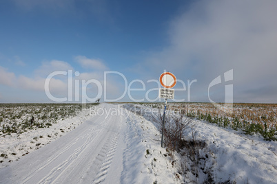Country road in winter. Text on the sign in German - Agricultural traffic free.