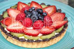 Large Fruit tart with mixed berries, including red strawberries