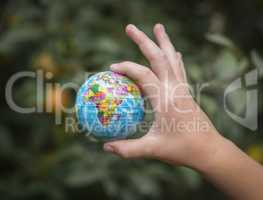 Small globe in a child's hand.