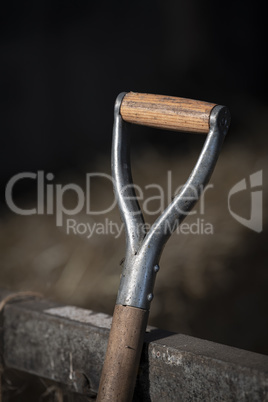 Wooden handle of a working tool on a farm.