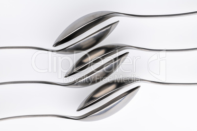 Artistic place setting photo of six spoons falling into each oth