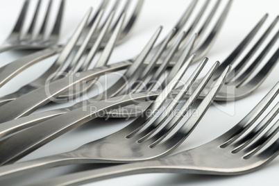 Artistic place setting photo of eight reclining forks.