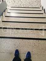 Legs on the background of the stairs going down