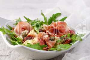 Arugula salad, prosciutto with sun-dried tomatoes