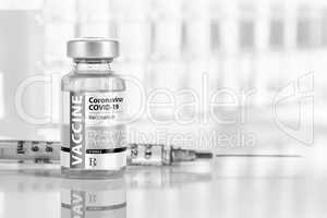 Coronavirus COVID-19 Vaccine Vial and Syringe On Reflective Surf