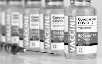 Coronavirus COVID-19 Vaccine Vials and Syringe On Reflective Sur