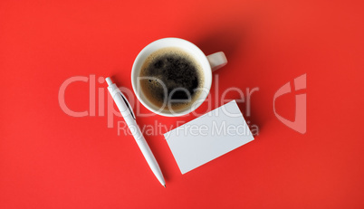 Business cards, coffee cup, pen