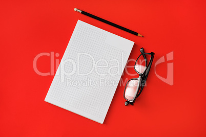 Copybook, pencil, glasses