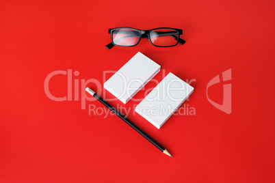 Business cards, pencil, glasses