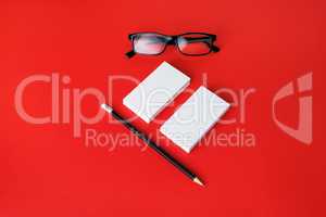 Business cards, pencil, glasses