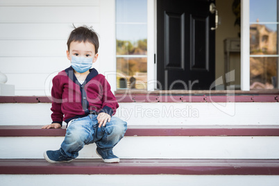 Melancholy Lonely Mixed Race Boy On Front Porch Wearing Medical