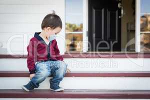 Melancholy Lonely Mixed Race Boy On Front Porch Wearing Medical