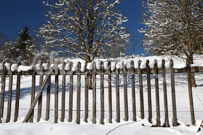 Wooden fence in the garden in winter