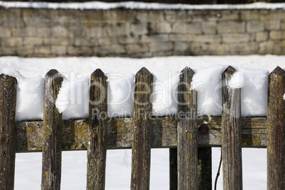 Wooden fence in the garden in winter