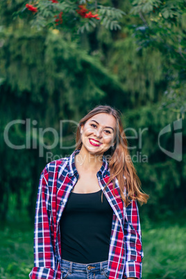 Smiling woman standing in the park