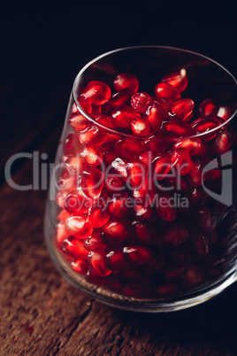 Glass full of red pomegranate seeds