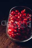 Glass full of red pomegranate seeds
