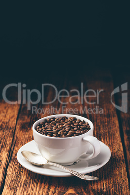 Roasted coffee beans in white cup