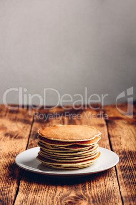 Stack of american pancakes on white plate