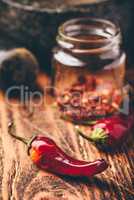 Dried red chili peppers on wooden surface