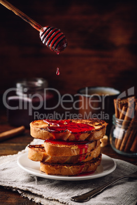Stack of french toasts with berry syrup