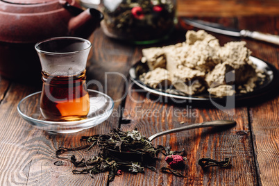 Spoonful of raspberry herbal tea and ready tea in armudu glass