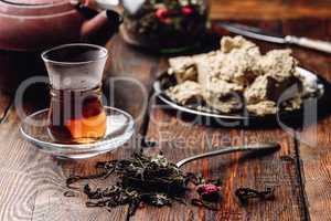 Spoonful of raspberry herbal tea and ready tea in armudu glass
