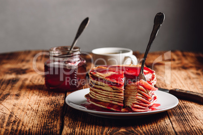 Stack of american pancakes with red berry jam