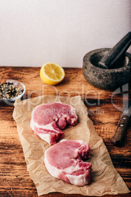 Two pork loin steaks with lemon and peppercorn