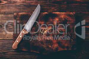 Knife over wooden cutting board