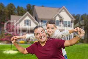 Hispanic Father and Mixed Race Son Having Fun In Front of House