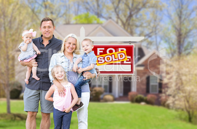 Happy Young Caucasian Family Outside In Front of Their New Home