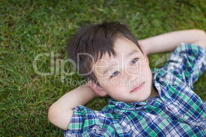 Thoughtful Mixed Race Chinese and Caucasian Young Boy Relaxing O