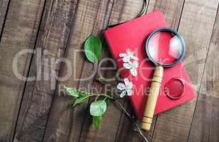 Notebook, magnifier, flowers