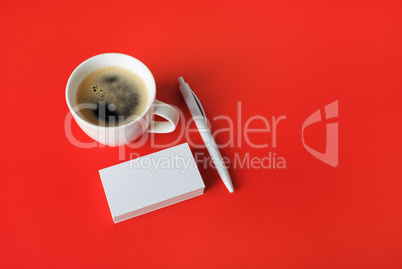 Business cards, coffee cup, pen